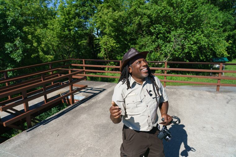 Lamar Gore, manager of the John Heinz National Wildlife Refuge, listens to birds sing.