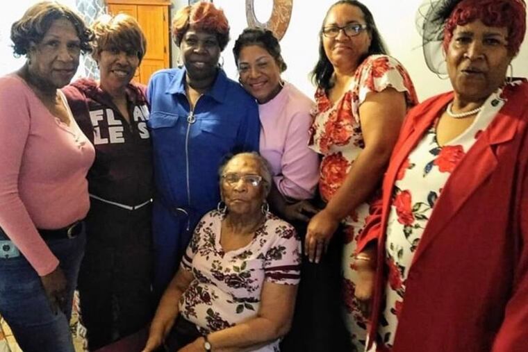 Mrs. Chester is surrounded by her daughters.