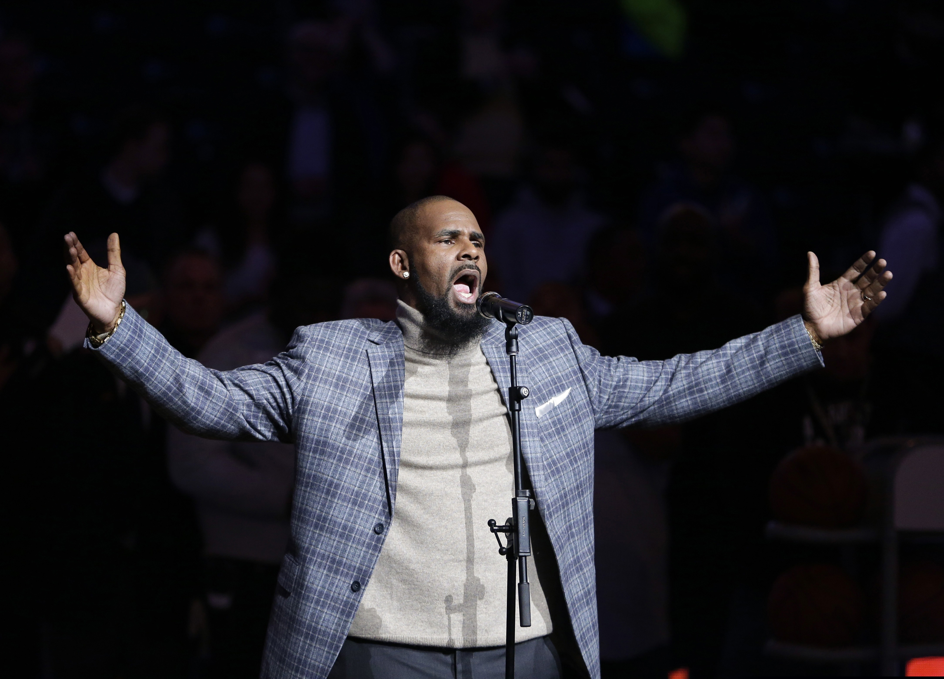In this Nov. 17, 2015, file photo, musical artist R. Kelly performs the national anthem before an NBA basketball game between the Brooklyn Nets and the Atlanta Hawks in New York.