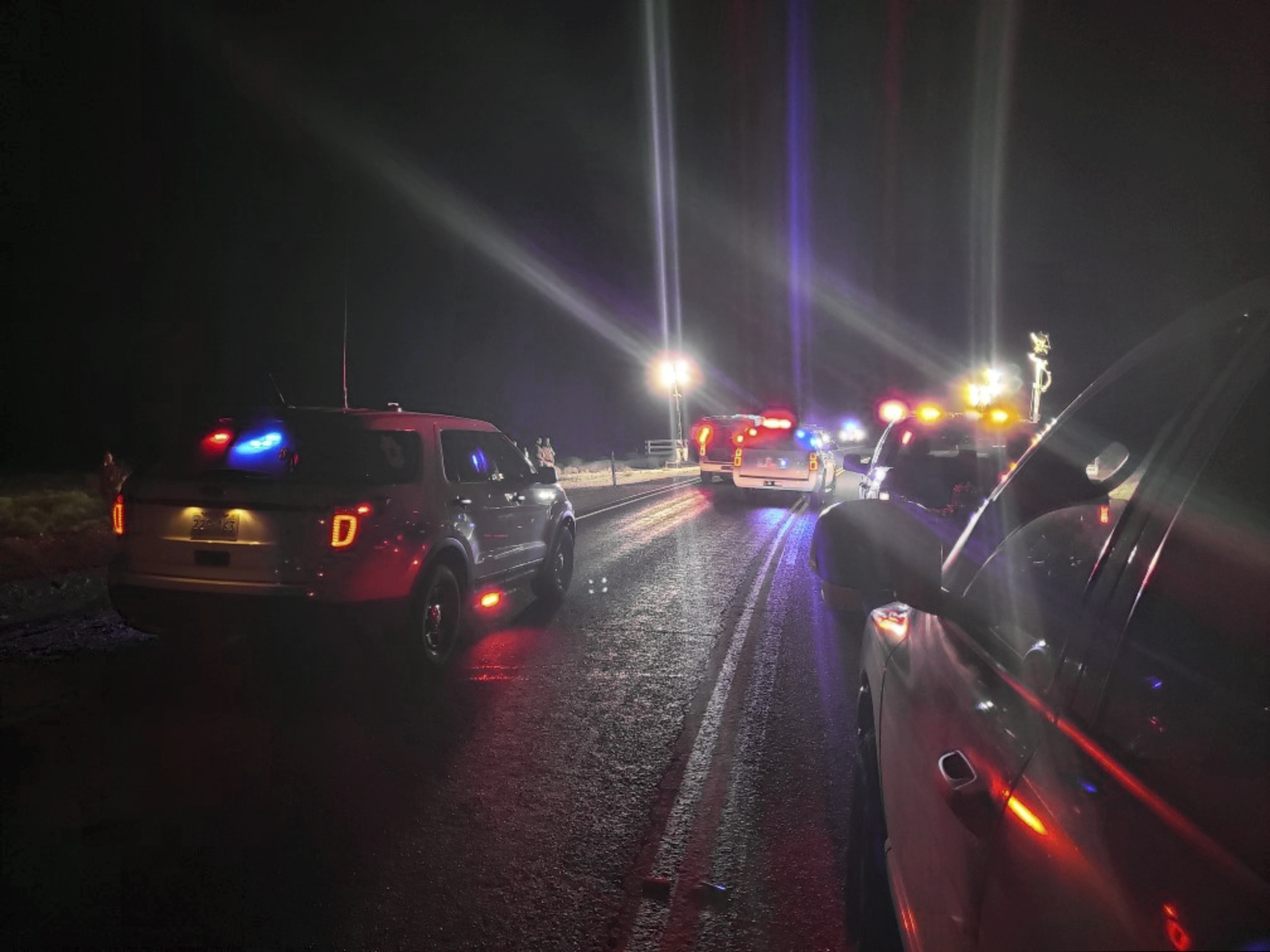 This photo provided by Nye County Sheriff's Office shows law enforcement agents investigate a shooting at the former Nevada Test Site north of Las Vegas on Monday, Jan. 28, 2019. Authorities shot and killed a man who entered a secured federal site north of Las Vegas where the government used to test nuclear bombs. A spokesman for the National Nuclear Security Administration says the man failed to stop at the security gate on Monday at the Nevada National Security Site. (Nye County Sheriff's Office via AP)