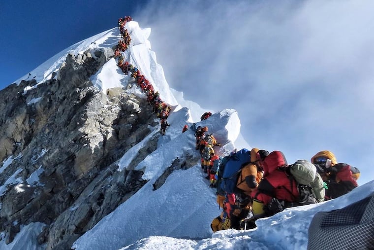 In this May 22 photo, a long queue of mountain climbers line a path to the summit of Mount Everest.