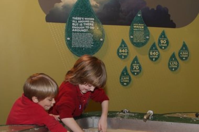 The stream table in the "Changing Earth" exhibit lets visitors explore how dams and water volume affect river flows and erosion.