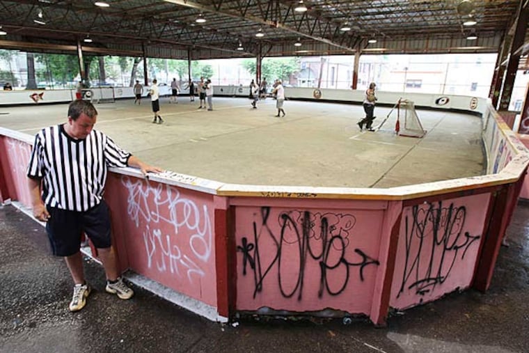 Men's street hockey action at Fishtown Rec Center's concrete rink, which is in serious need of repair. ( Steven M. Falk / Staff Photographer)