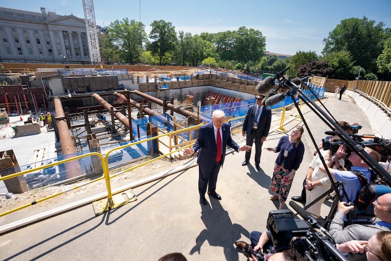 President Donald Trump speaks to reporters at the site of his ballroom project on the White House grounds in Washington, May 19, 2026. A government database shows that $352 million in funds intended for Secret Service recruitment and training was moved to help pay for security for the new East Wing.