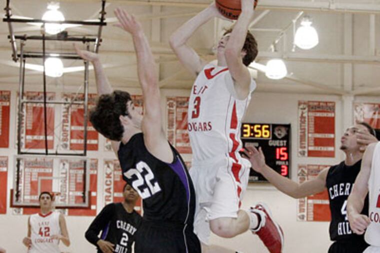 Cherry Hill East's Jake Silpe shoots over West defender Gregory Smolsky. (Elizabeth Robertson / Staff Photographer)