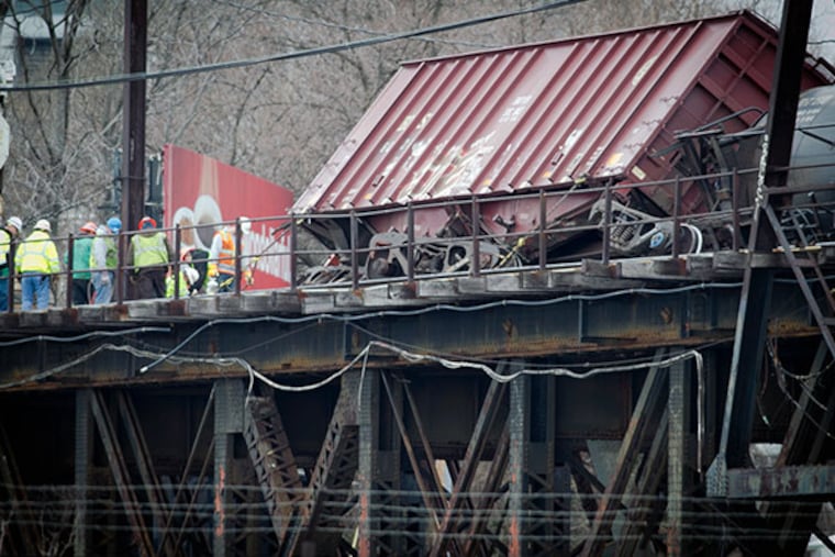 A box car sits on its side as workers prepare to upright it early Monday, January 20, 2013. ( ALEJANDRO A. ALVAREZ / STAFF PHOTOGRAPHER )
