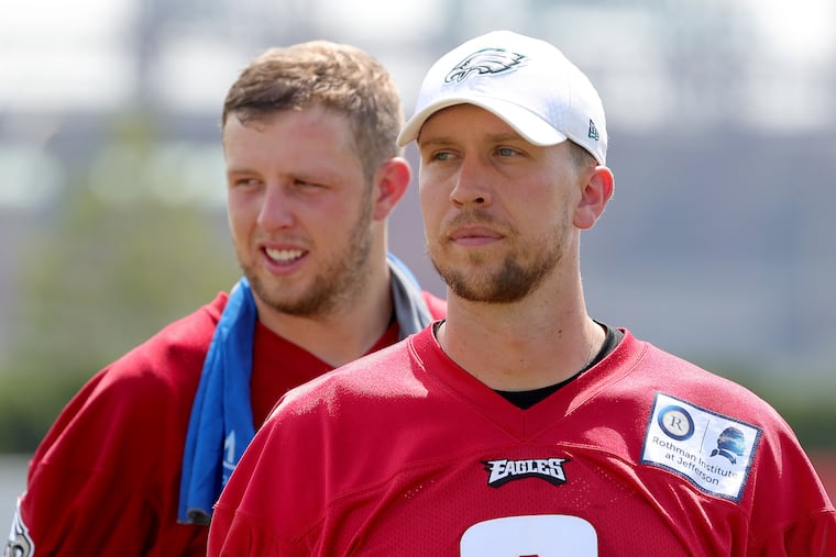 Eagles' Nate Sudfeld, left, and Nick Foles walks off the field after Eagles training camp at the NovaCare Complex in Philadelphia, PA on August 6, 2018. DAVID MAIALETTI / Staff Photographer