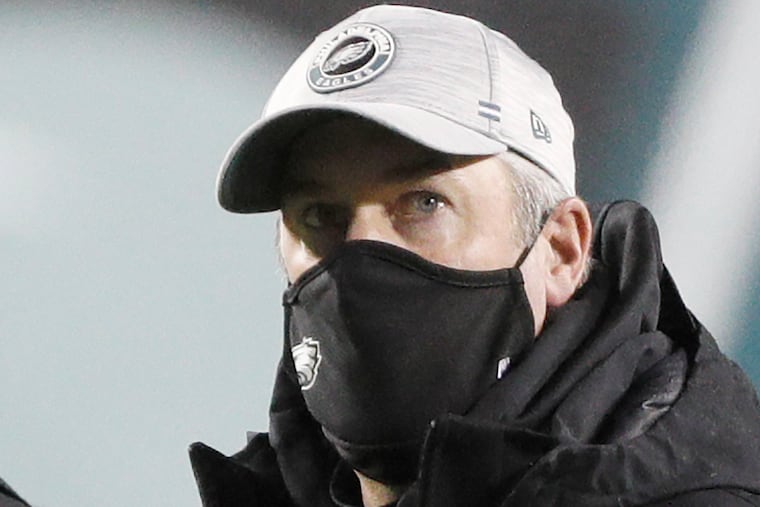 Doug Pederson walks off the field after the Eagles' 20-14 loss to Washington on Sunday.