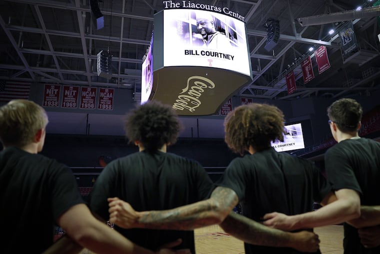 Temple players pause during a moment of silence for coach Bill Courtney, who died unexpectedly on Jan. 13.