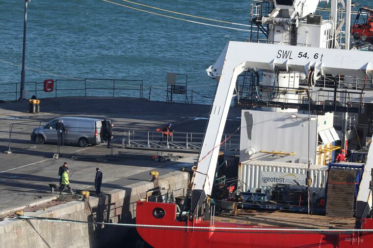 A van stands by the Geo Ocean III specialist search vessel docked in Portland, England, which is carrying a body recovered from the wreckage of the plane carrying Cardiff City footballer Emiliano Sala and pilot David Ibbotson, Thursday Feb. 7, 2019. (Steve Parsons / PA via AP)