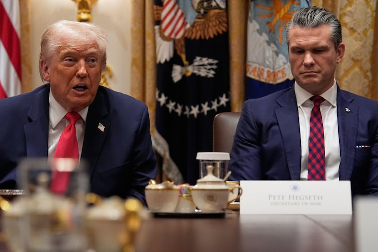 President Donald Trump speaks during a cabinet meeting at the White House on Tuesday as Defense Secretary Pete Hegseth looks on.