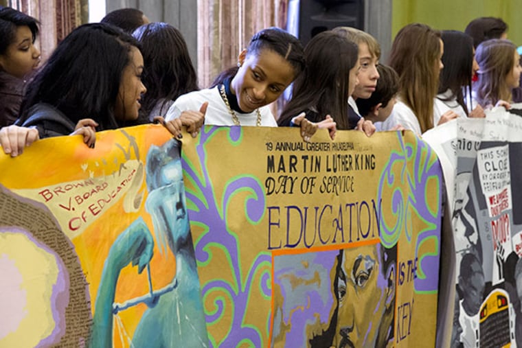 Taja Thornton, a 17-year-old senior at Cherry Hill West (2nd from left), along with students from six area schools proudly display the civil rights mural they painted to commemorate the upcoming 19th annual Greater Philadelphia Martin Luther King Day of Service at Girard College Jan. 8, 2014. 125,000 vounteers are expected to participate this year. ( CLEM MURRAY / Staff Photographer )