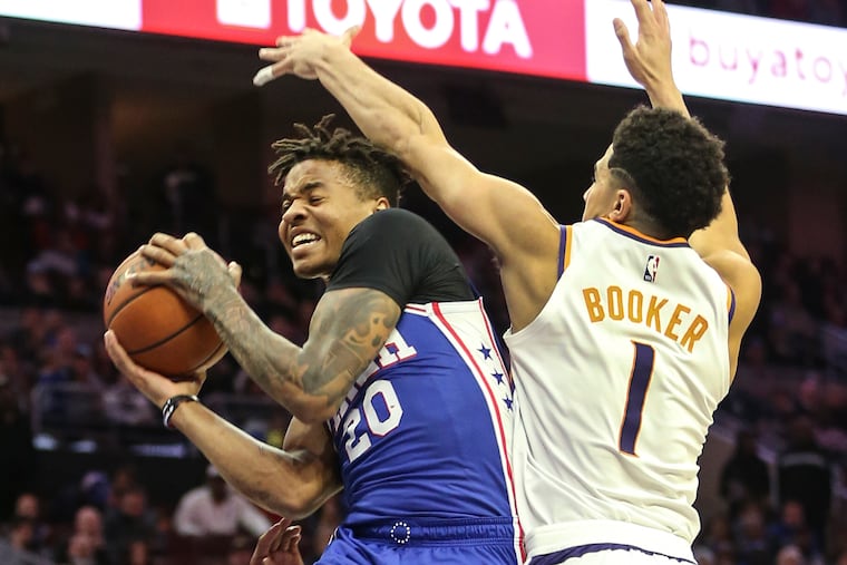 Sixers' Markelle Fultz goes up against Suns' Devin Booker during the 2nd quarter at the Wells Fargo Center in Philadelphia, Monday, November 19, 2018. STEVEN M. FALK / Staff Photographer