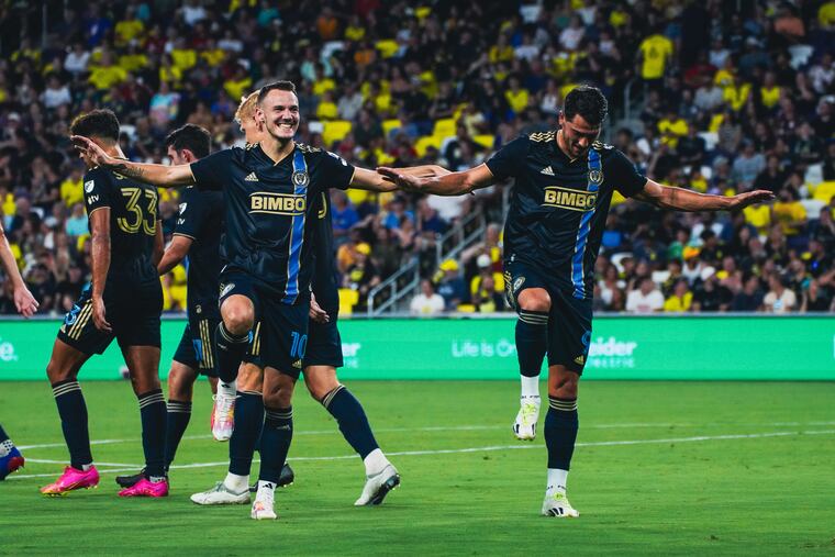 Dániel Gazdag (left) celebrates his first goal of the game with Julián Carranza.