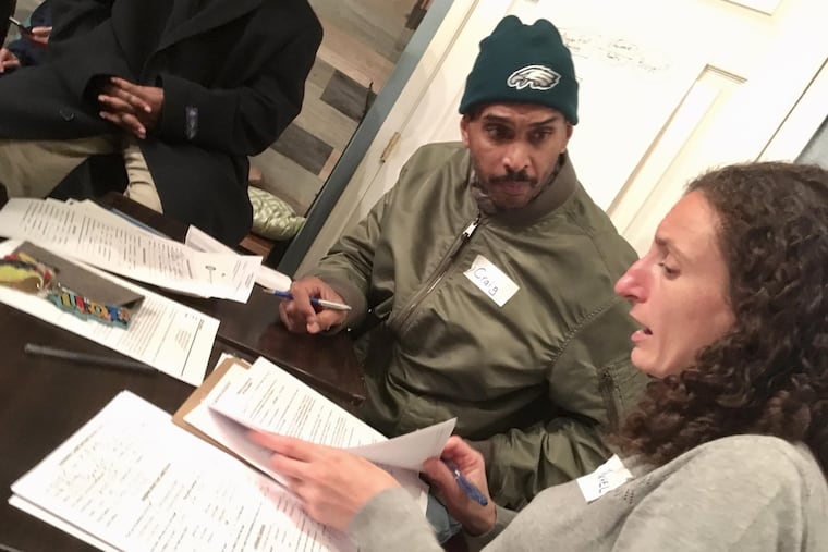 Rachel Garland, a lawyer with Community Legal Services, meets with Craig K. Lee, 53, who has lived at the Arvilla since 2011 and now will have to move.