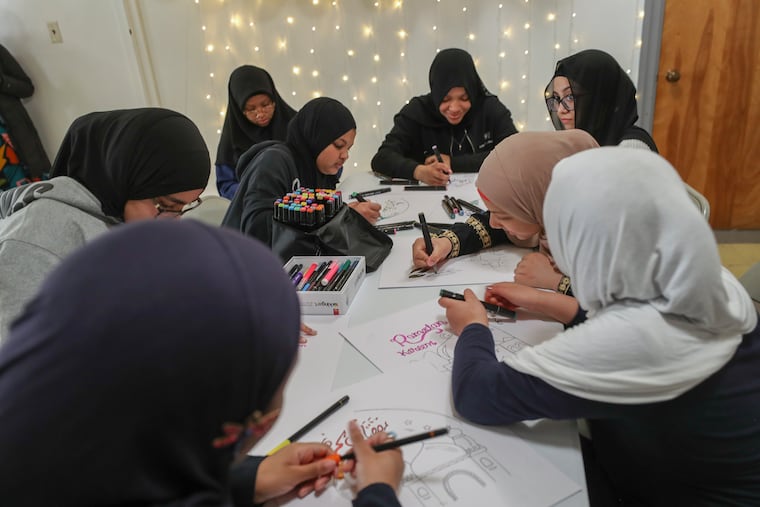 Students at the Norristown Islamic Society make decorations for the start of Ramadan.