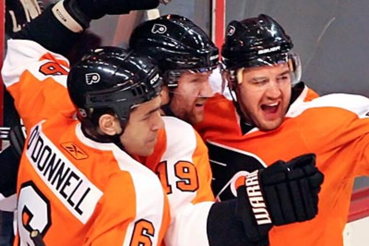 Sean O'Donnell (left) and Andrej Meszaros (right) recorded assists on Danny Briere's goal. (Steven M. Falk/Staff Photographer)