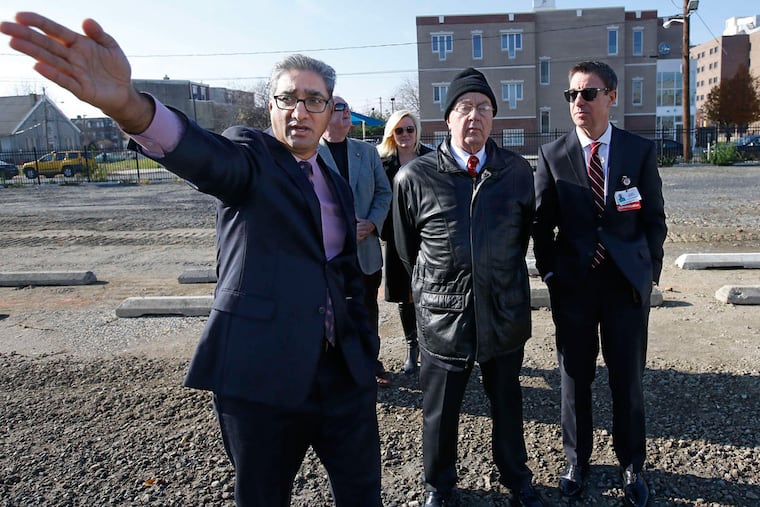 Kris Kolluri (left), CEO of the Rowan University/Rutgers-Camden Board of Governors, with board members Bob Mortensen (center) and Louis Bezich.
