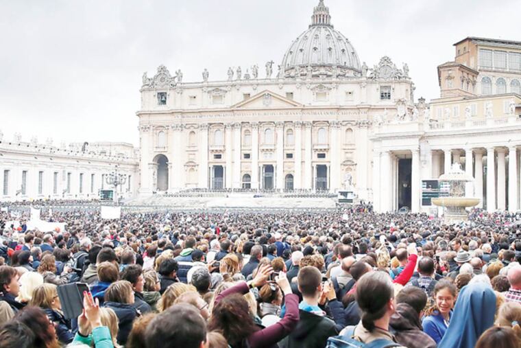 A crowd gathers on Sunday at noon for the Angelus prayer when the Pope speaks from his window overlooking St. Peter's Square in Vatican City on March 23, 2014. ( DAVID MAIALETTI / Staff Photographer )