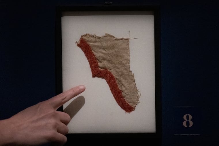 Museum staffer Beth Ann Downey points at a fragment of a George Washington’s war tent displayed on Wednesday, July 10, 2024, at the Museum of the American Revolution in Philadelphia, Pa. A Virginia man bought the fragment from a Goodwill auction for $1,300.