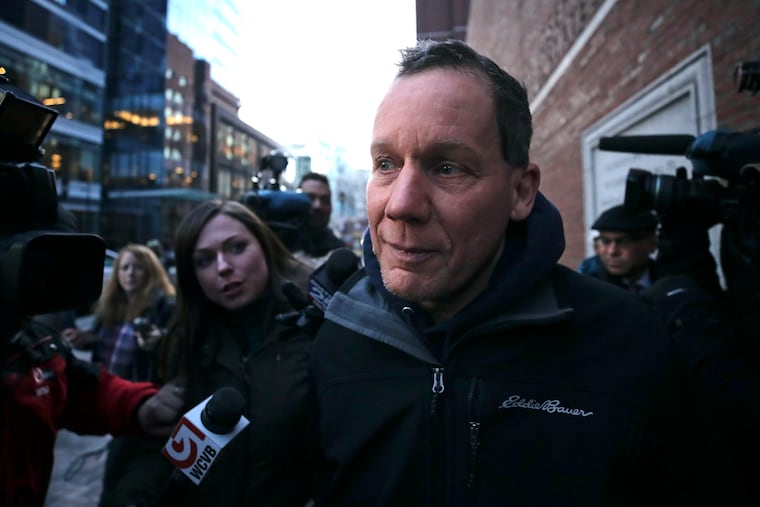 Harvard University professor Charles Lieber is surrounded by reporters as he leaves the Moakley Federal Courthouse in Boston on Jan. 30, 2020. The FBI has accused Leiber, chair of the department of chemistry and chemical biology, of lying to officials about his involvement with a Chinese government-run recruitment program through which he received tens of thousands of dollars.