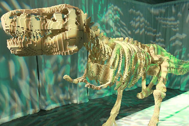 Nathan Sawaya's "Dinosaur Skeleton," on display at the Franklin Institute, is made of 80,020 snapped-and-glued Lego pieces. It's part of a show of Sawaya's Lego works. (DAVID SWANSON / Staff Photographer)