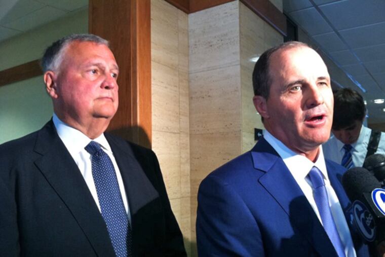 Robert J. Kerns (left) stands by as his lawyer, Brian J. McMonagle, talks about having the most serious charges against Kerns dismissed. (Carolyn Davis/Staff)