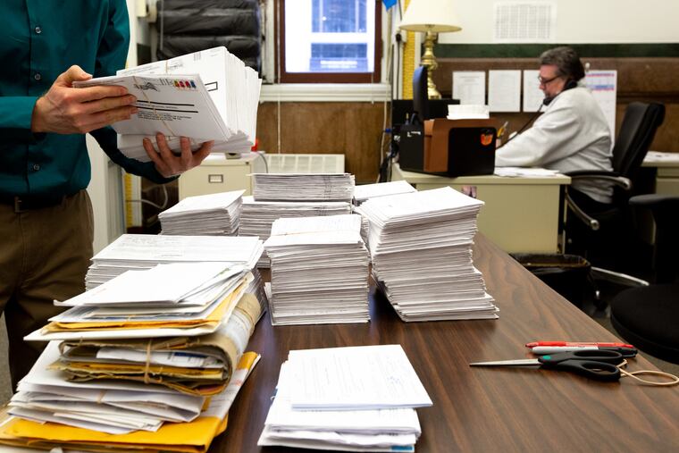 In a file photo, a worker counts Philadelphia absentee ballots that arrived after the deadline to be counted in the November 2018 midterm election.