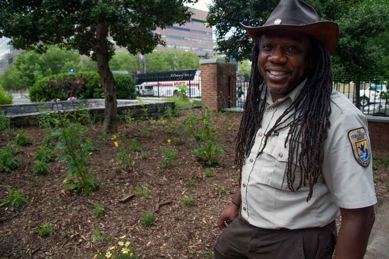 Lamar Gore of the John Heinz National Wildlife Refuge in a pocket park behind the Free Quaker House where monarchs can feed during migrations.