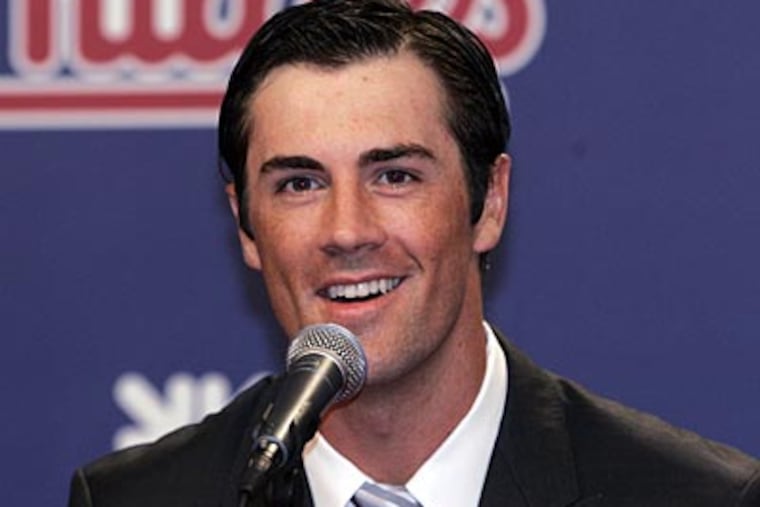 Cole Hamels signed a six-year, $144 million extension with the Phillies on Wednesday. (Tom Mihalek/AP)