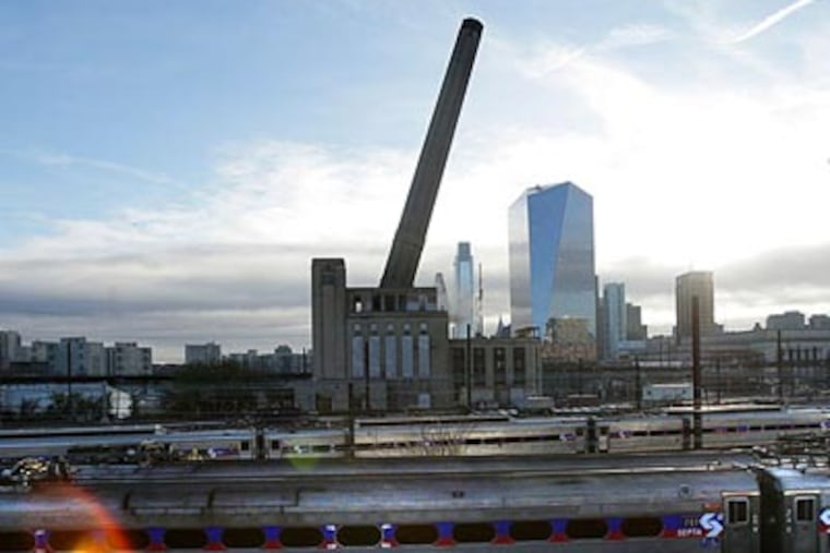 Demolition of the Pennsylvania Railroad steam plant's smokestack, near Amtrak's 30th Street station. (David Maialetti / Staff)