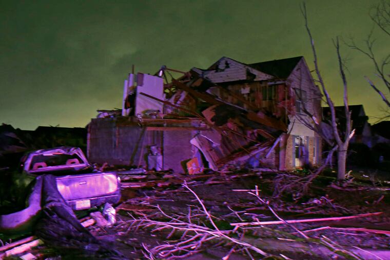 A house sits in ruins after a tornado blew through Rowlett, Texas, on Saturday night. Story, A10