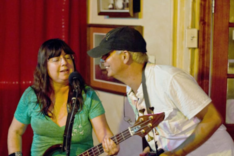 At Barrington Coffee House, owner Scott "Trif" Trifeletti sings with Sue Pepiak. "There's an amazing amount of talent there," he says. (Luis Fernando Rodriguez / Staff Photographer)