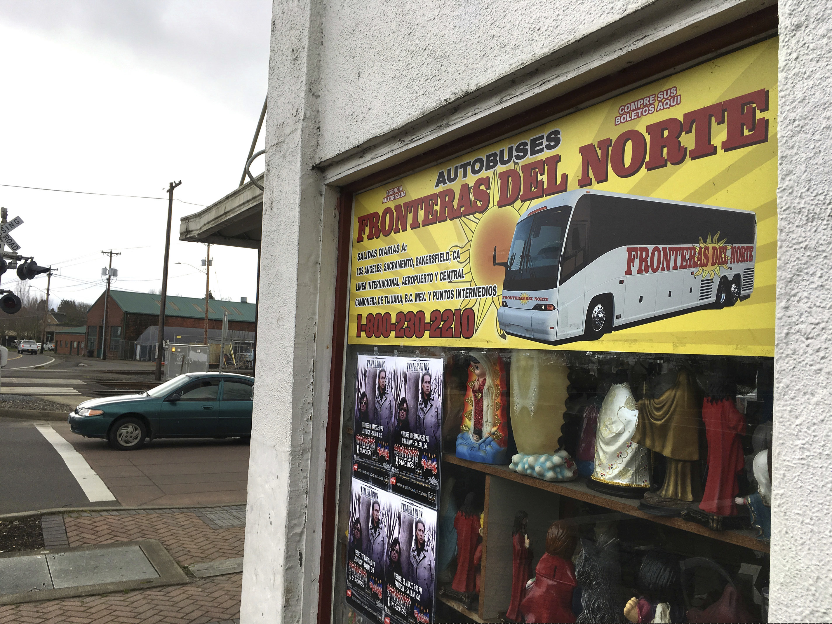 FILE - This March 2, 2017, file photo shows a sign advertising bus trips to California with connections to Mexico, at a shop in the predominantly Latino town of Woodburn, Ore. A man from Woodburn has pleaded guilty to conspiracy to produce false documents after agents found a document-forging lab in his apartment that had allegedly produced over 10,000 fake social security cards, drivers licenses and immigration-related documents. (AP Photo/Andrew Selsky, File)