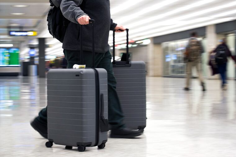 FILE - In this March 26, 2019, file photo, an airline passenger walk in the arrivals terminal at Dulles International Airport in Dulles, Va. Newly documents filed in a federal lawsuit claim that U.S. government searches of phones and laptops at airports are on the rise and are being conducted for reasons beyond immigration and customs enforcement. There were 33,295 searches in fiscal 2018. (AP Photo/Cliff Owen, File)