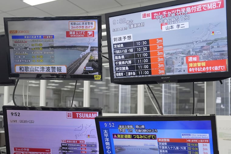 TV monitors show news flash after a powerful earthquake in Russia's Far East prompted tsunami warnings in parts of Japan, in Osaka, western Japan Wednesday, July 30, 2025. (Kai Naito/Kyodo News via AP)