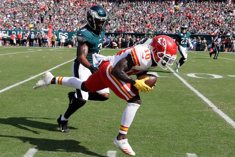 Kansas City Chiefs wide receiver Tyreek Hill catches the football past Eagles cornerback Steven Nelson during the second quarter on Sunday, October 3, 2021 in Philadelphia.