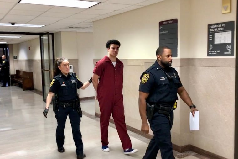 Mason Hall, 22, is escorted out of a courtroom in Norristown after his sentencing hearing on rape charges.