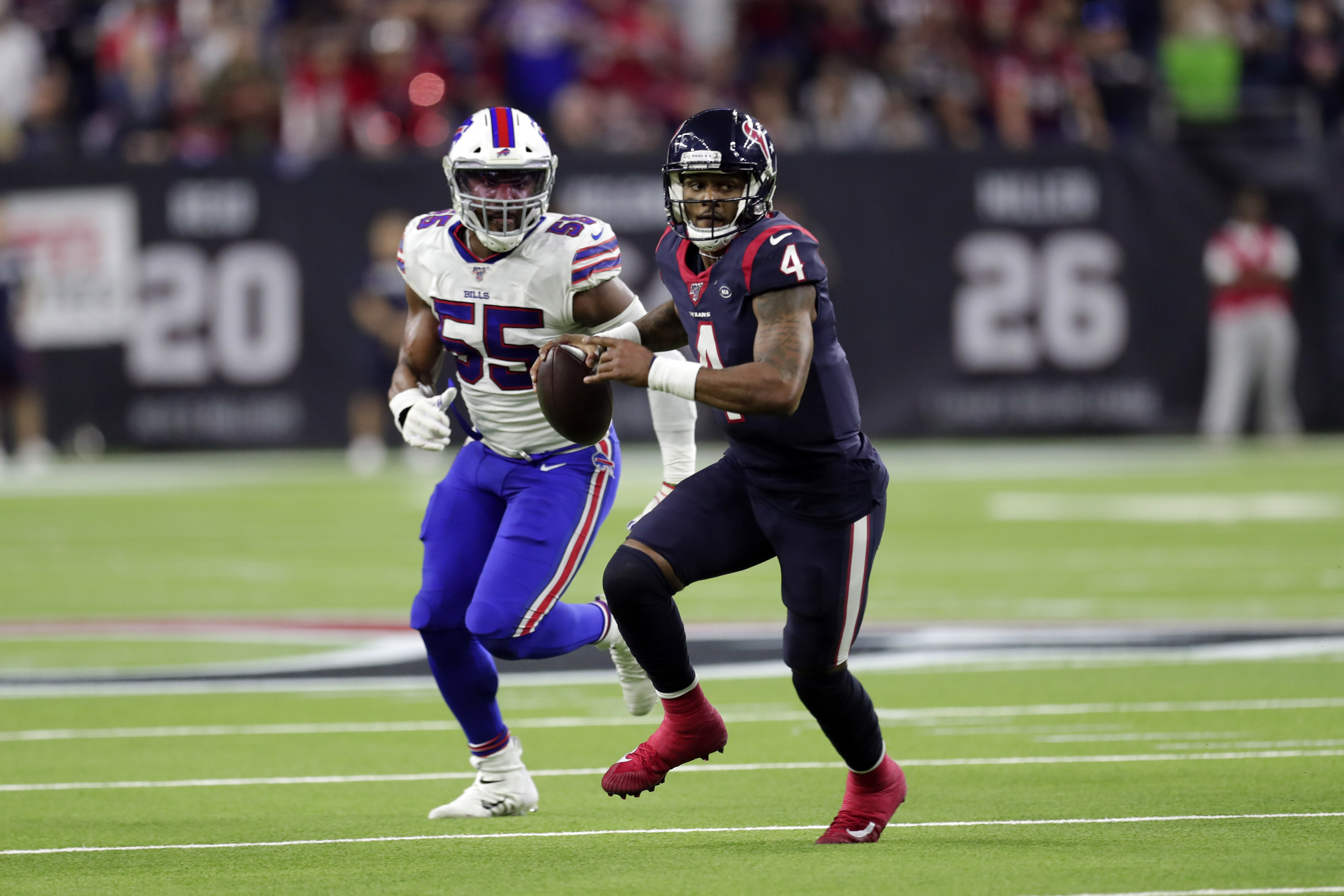 Houston Texans quarterback Deshaun Watson scrambles away from Buffalo Bills defensive end Jerry Hughes.