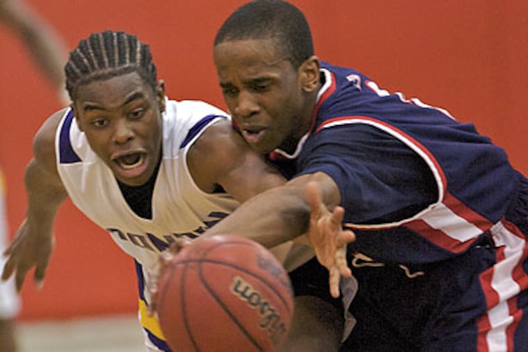 Camden's Deon Devine knocks the ball out of the hands of Willingboro's Jarvis Perry with two minutes left in the fourth quarter. (John Costello / Staff Photographer)