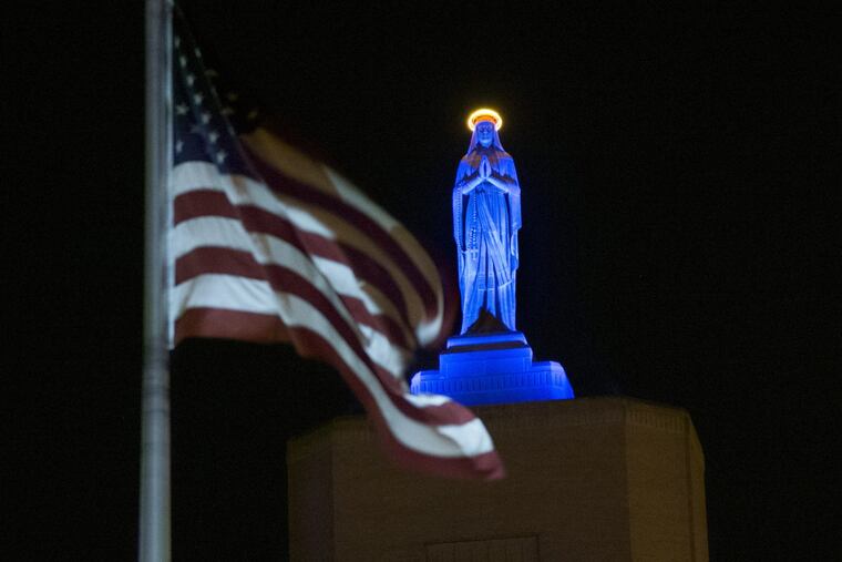 The Virgin Mary statue atop Our Lady of Lourdes Medical Center in Camden, as it looked when lighted blue in November in honor of the Chicago Cubs’ World Series victory.