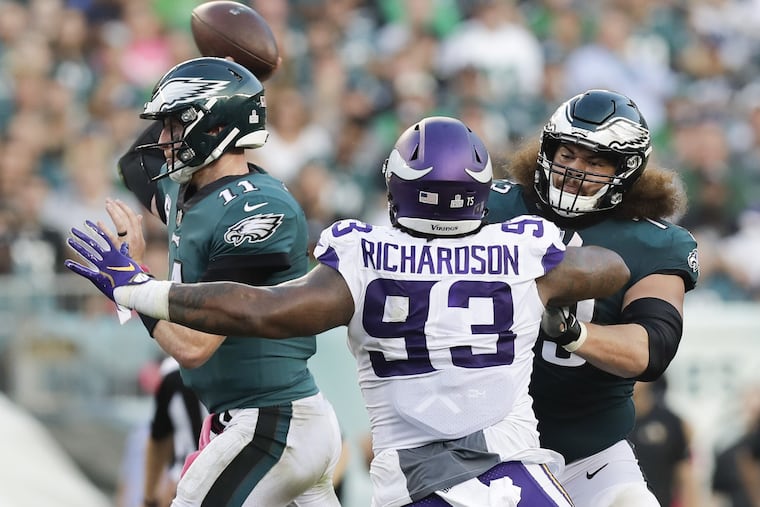 Eagles quarterback Carson Wentz throws the football as offensive guard Isaac Seumalo blocks Minnesota Vikings defensive tackle Sheldon Richardson during the third-quarter on Sunday, October 7, 2018 in Philadelphia. YONG KIM / Staff Photographer