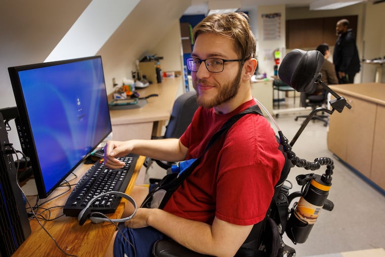 Nikos Rapach, a resident of Inglis House, sets up at his workstation in the computer lab.