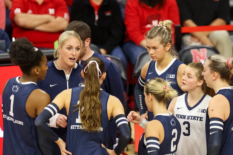 Penn State head coach Katie Schumacher-Cawley, second from left, talks with her team during a timeout during the first set of an NCAA college volleyball match against Nebraska in October.
