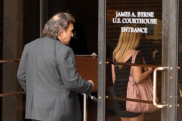 Holly and Michael Robbins, the parents of Harriton High School sophomore Blake Robbins, arrive at Federal Court on Wednesday. ( Tom Gralish / Staff Photographer )