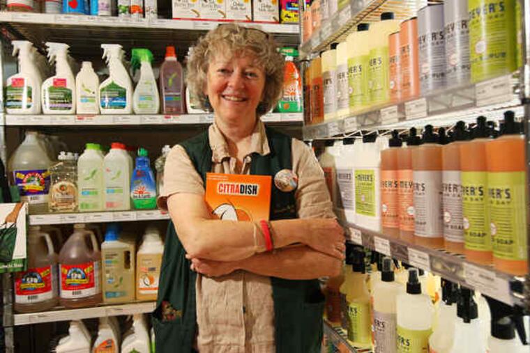 Martha Fuller, a manager at Weavers Way, holds her favorite phosphate-free dishwasher powder, Citrusdish. The Philadelphia co-op has a large selection of eco-friendly cleaners. "Your glasses aren't going to be shiny-sparkly," says one committed user.