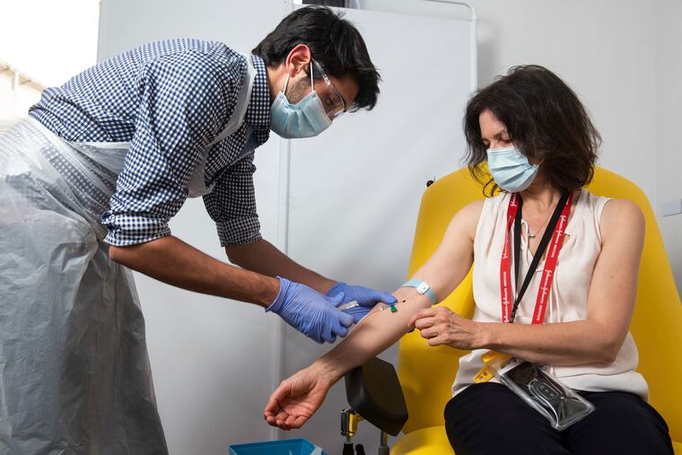 In this photo issued by the University of Oxford, a volunteer gets the coronavirus vaccine developed by AstraZeneca and Oxford University, in Oxford, England. Pharmaceutical company AstraZeneca said Monday that late-stage trials showed its coronavirus vaccine was up to 90% effective, giving public health officials hope they may soon have access to a vaccine that is cheaper and easier to distribute than some of its rivals.