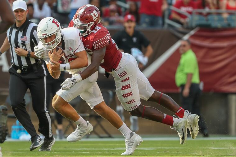 Temple linebacker Layton Jordan sacks Rutgers quarterback Evan Simon in the fourth quarter at Lincoln Financial Field on Saturday. Jordan finished with two sacks.