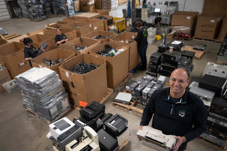 Serdar Bankaci, president of CyberCrunch, an electronics recycling and data destruction service, poses with electronic refuse to be destroyed at the company’s facility in Greensburg, Pa.