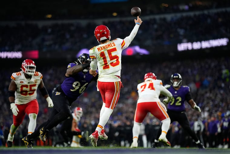 Kansas City Chiefs quarterback Patrick Mahomes passes under pressure from Baltimore Ravens defensive tackle Broderick Washington (96) during the second half Sunday.